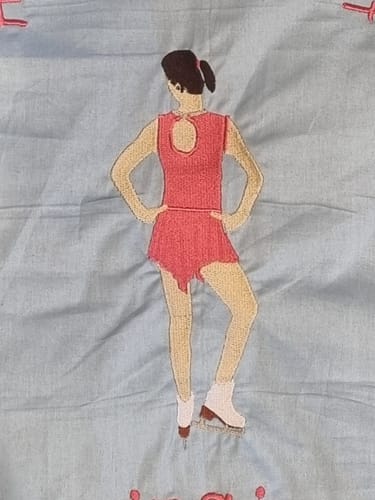 Customer's embroidered project of an ice skater in a pink outfit, made with the bernette by BERNINA B79 sewing machine.