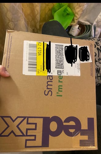 Customer holding the FedEx shipping box containing the BTS - GQ KOREA MAGAZINE.