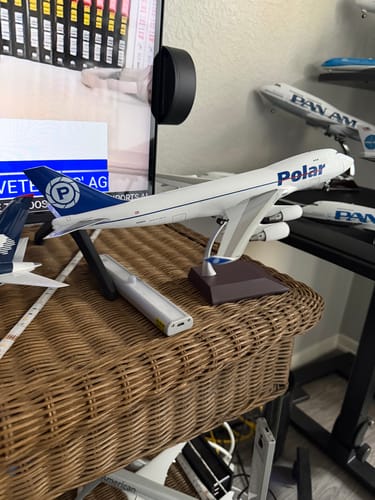 Customer's Polar Air Cargo 747-400F model airplane on its display stand on a wicker table.