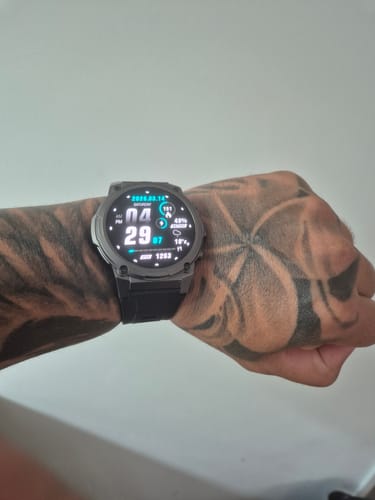 Customer's black digital watch displayed on a tattooed wrist.