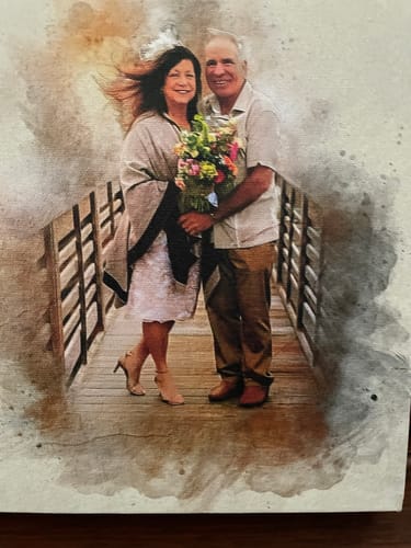 Customer's personalized photo painting showing a couple on a wooden walkway with a colorful bouquet.