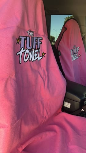 Customer's two pink Tuff Towel seat covers installed on the front seats of a car.