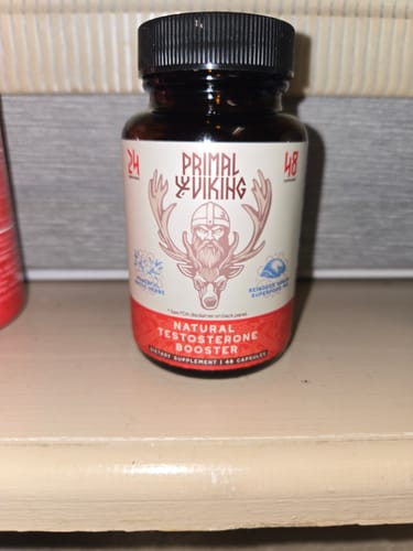 Customer's bottle of Primal Reindeer Testosterone Support sitting on a wooden shelf.