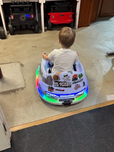 Customer shows the BAND-AID stickers decorating their child's white ride-on toy car.