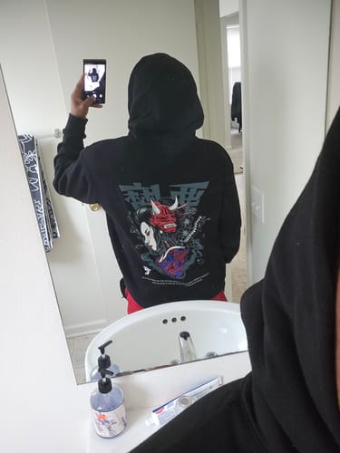 Customer showing the back print of the black DARK GEISHA HOODIE in a mirror selfie.