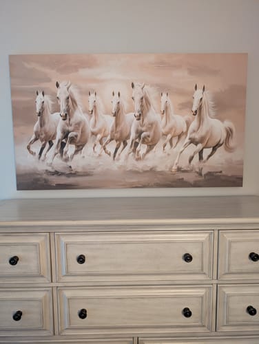 Customer's 'Seven White Running Horses' canvas hanging on a wall above a neutral-toned dresser.