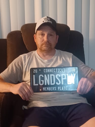 Customer displays a black 'LGNDSPLY Members Plate' representing their LGND Membership.