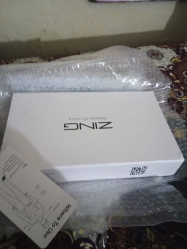 Customer's white box for the OUD Supreme BUNDLE, shown partially in bubble wrap next to an instruction card.