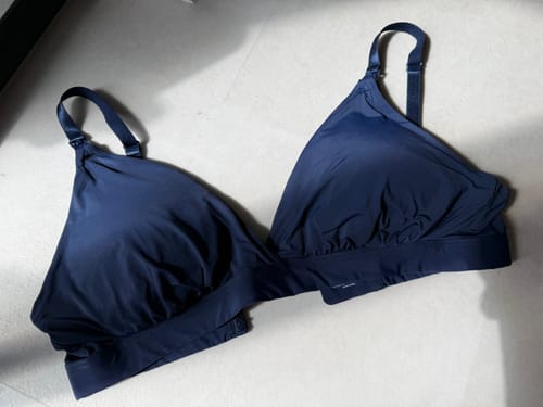 A reviewer's dark blue Holiday Triangle Nursing Bra from the exclusive kit, laid flat on a light surface.