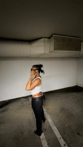 Customer showing the side profile and fit of the low-rise black Vice Pant.