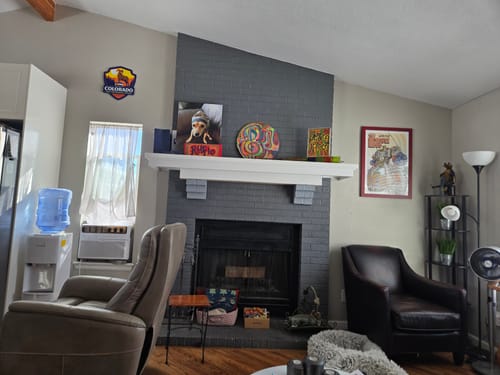 Customer's Colorado State Badge 3D Metal Wall Art hanging on a living room wall next to a fireplace.