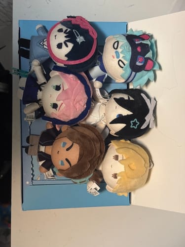 Customer's collection of six plush Alien Stage Mini Doll Pendants arranged inside their open display box.