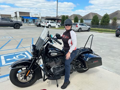 Reviewer wearing the Polo Featherlight Flat Black helmet while sitting on a motorcycle in a parking lot.