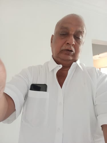 Customer wearing the short-sleeved Double Delight White Shirt indoors with a phone in the pocket.