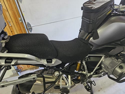 Customer's black mesh Wind Rider Seat Cover installed on a motorcycle in a garage.