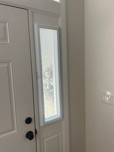Customer's Add On Blinds Kit installed on a single sidelight window next to a white door.