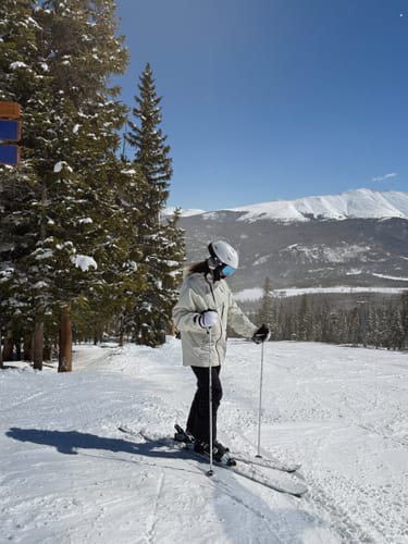 Reviewer wearing the off-white snow jacket while skiing on a sunny mountain.