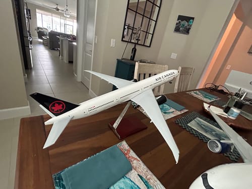 Customer's SKYMARKS AIR CANADA 777-300 model airplane assembled on its wood stand on a dining table.