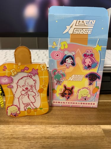 Reviewer's Alien Stage Rabbit Series acrylic ice cream keychain placed beside its blue and white blind box packaging.