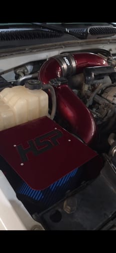 Customer's red Duramax Cold Air Intake Bundle installed in their truck's engine bay.