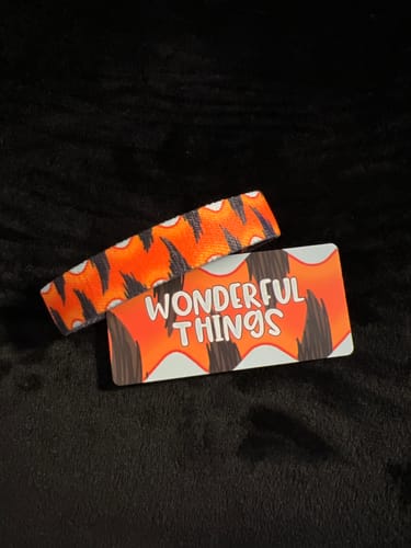 Customer's Wonderful Things Bracelet with its orange and black striped design, shown with the matching "Wonderful Things" card.