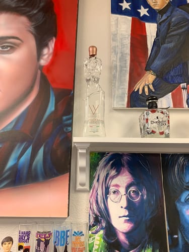 Verified customer photo of a sculptural Vavoom Vodka bottle displayed among colorful music-themed artwork.