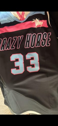 Close-up of the customer's black custom basketball jersey showing "CRAZY HORSE" and the number 33 in light blue and pink.