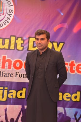 Reviewer at an event, wearing a black blazer over traditional clothing.
