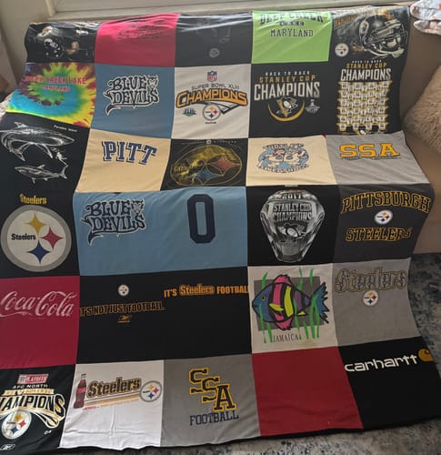 Reviewer's finished Project Repat T-Shirt Quilt, made with panels from various sports, school, and personal t-shirts.