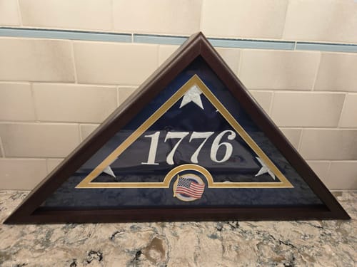 Customer's dark wood US Flag Display Case holding a '1776' flag with the included medallion.