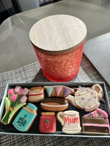 Customer's Afternoon Tea Deluxe Biscuit Box with nine decorated biscuits shaped like a teapot, cake, and mug.