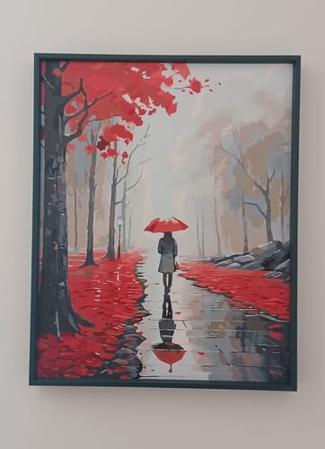 Customer's completed Red Umbrella Walk paint by numbers kit, displayed in a dark green frame on a wall.