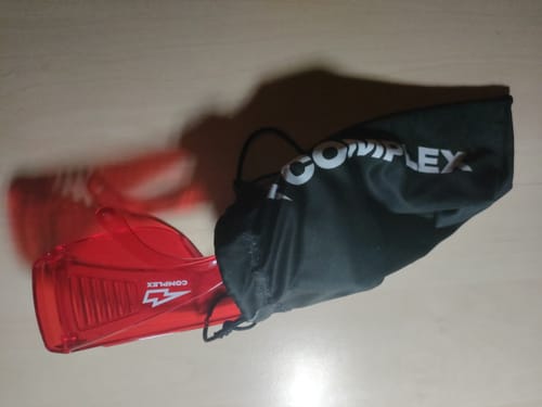 A customer's red VisionX glasses shown with the black drawstring carrying bag.