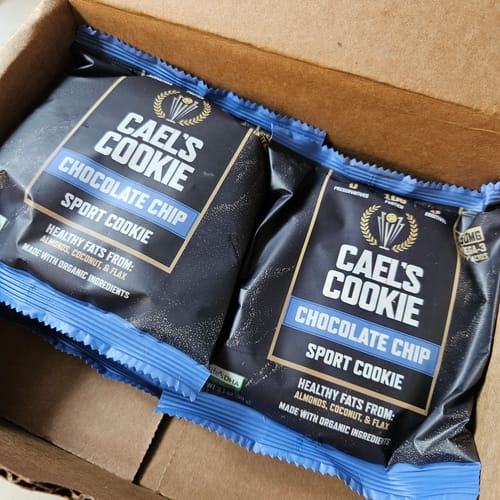 Customer's two Cael’s Cookie Chocolate Chip sport cookies shown in their individual wrappers inside a shipping box.