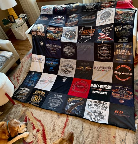 Customer's Premium T Shirt Quilt made from Harley-Davidson t-shirts, spread out over a sofa.