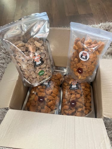 Customer's delivery box containing four large refill bags of BBQ flavour and Salt & Vinegar pork scratchings.
