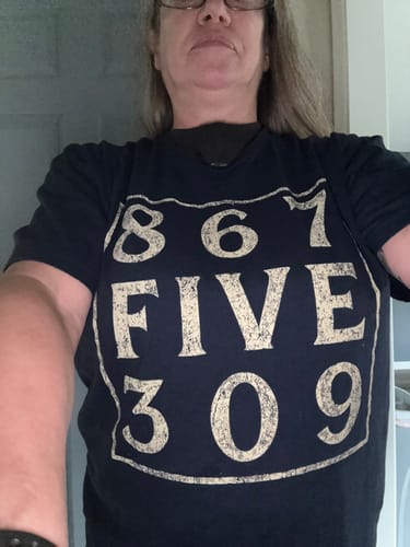 Close-up of a customer wearing the dark 8675309 T-Shirt, showing the front graphic.