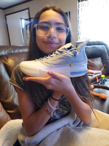 Customer smiling while holding a new, light-blue Joker 1 GT "Denver" shoe.