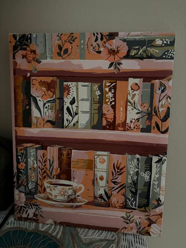 Customer's finished Blooming library paint-by-number showing floral books on pink shelves with a teacup.