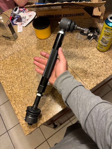 Customer holding a complete, adjustable heavy-duty tie rod end over a countertop.