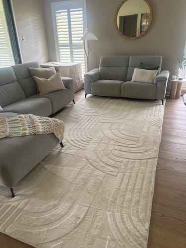 Customer's cream Mellow Mat with a carved 3D design placed in a modern living room.