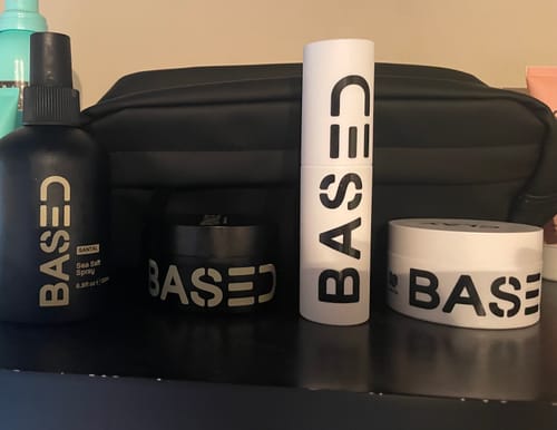 Customer's Complete Styling Kit products, including a spray and pomade jars, displayed on a dark shelf.