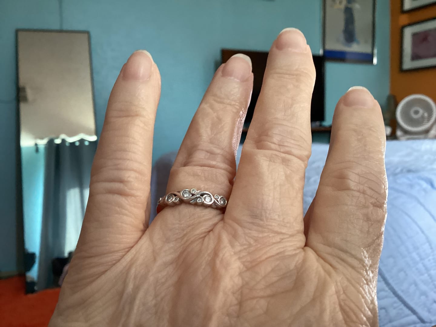 Customer photo review of Bezel Set Round Moissanite Scroll Accents Wedding Band Ring In Sterling Silver