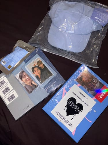 Customer's K-POP RANDOM BOX showing Seventeen albums, photocards, and a light blue cap.