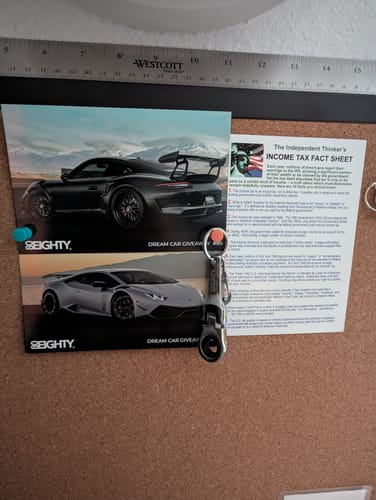 Customer's 80Eighty 10mm Wrench Keychain hanging on a corkboard in front of promotional flyers.