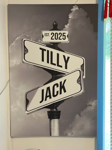 Customer's personalized black and white canvas showing street signs with the names 'Tilly,' 'Jack,' and 'Est. 2025'.