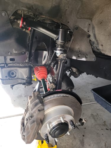 Customer's close-up of the black Upper Control Arms installed in the wheel well of their vehicle.