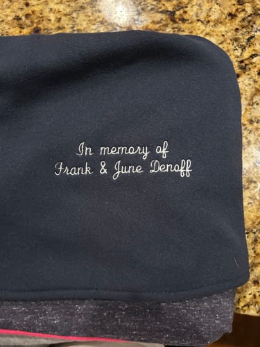 Close-up of the custom memorial embroidery on the back of a customer's black fleece Premium T-Shirt Quilt.