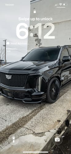 Customer's phone lock screen with the Fast Pass digital screensaver of a custom black SUV.