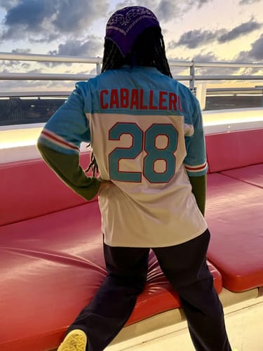 Reviewer showing the back of their Puerto Rico Heritage Football Jersey with 'CABALLERO' and the number 28.